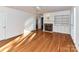 Bright living room features hardwood floors, a brick fireplace, and built in bookshelves at 2050 Tite Rd, Stanfield, NC 28163