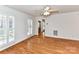 Bright living room with hardwood floors and large shuttered windows for plenty of natural light at 2050 Tite Rd, Stanfield, NC 28163