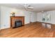 Spacious living room with hardwood floors, a brick fireplace, and access to an outdoor deck at 2050 Tite Rd, Stanfield, NC 28163