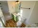 Modern bathroom features a green vanity, updated fixtures, and wood-look tile at 257 Doughton Ln, Charlotte, NC 28217