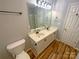 Double vanity bathroom with updated fixtures and wood-look flooring at 257 Doughton Ln, Charlotte, NC 28217