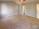 Spacious primary bedroom with neutral walls, carpet flooring, and vaulted ceiling at 257 Doughton Ln, Charlotte, NC 28217