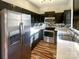 Modern kitchen with stainless steel appliances and dark cabinets at 257 Doughton Ln, Charlotte, NC 28217