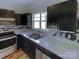 Modern kitchen features dark cabinets, stainless steel appliances, and marble backsplash at 257 Doughton Ln, Charlotte, NC 28217