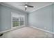 Bright bedroom with a large window, ceiling fan and neutral carpet at 2880 Harmony Rd, Rock Hill, SC 29730