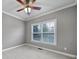 A cozy bedroom with a ceiling fan, large window, and soft carpet flooring at 2880 Harmony Rd, Rock Hill, SC 29730