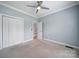 The bedroom features neutral walls, a ceiling fan, and a closet for storage at 2880 Harmony Rd, Rock Hill, SC 29730