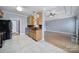 Well-lit kitchen featuring wood cabinets, black appliances, and tile flooring open to the living area at 2880 Harmony Rd, Rock Hill, SC 29730