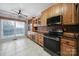 Cozy kitchen featuring ample wood cabinets, a modern range, and a view from the window at 2880 Harmony Rd, Rock Hill, SC 29730