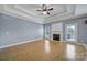 Bright living room with laminate floors, a fireplace, and a tray ceiling at 2880 Harmony Rd, Rock Hill, SC 29730