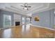 Sunlit living room with laminate floors, a fireplace and kitchen access at 2880 Harmony Rd, Rock Hill, SC 29730