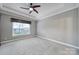 Neutral bedroom is spacious with a ceiling fan, a large window, and soft carpet flooring at 2880 Harmony Rd, Rock Hill, SC 29730