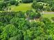 Aerial view showing rural homes surrounded by farmland and lush forests at 2988 Great Falls Hwy, Lancaster, SC 29720
