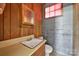 Small bathroom with wood cabinets and a toilet at 2988 Great Falls Hwy, Lancaster, SC 29720