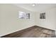 Simple bedroom with hardwood floors and two windows at 2988 Great Falls Hwy, Lancaster, SC 29720