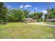 Exterior view of a single-story home with an adjacent garage and spacious yard with a brick building at 2988 Great Falls Hwy, Lancaster, SC 29720