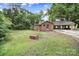 View of the exterior of the brick home with a carport surrounded by a lush green lawn at 2988 Great Falls Hwy, Lancaster, SC 29720