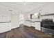Updated kitchen with white cabinets, stainless steel appliances, and dark floors at 2988 Great Falls Hwy, Lancaster, SC 29720