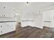 White kitchen cabinets, dark countertops, and stainless steel appliances at 2988 Great Falls Hwy, Lancaster, SC 29720