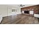 Living room with brick fireplace, hardwood floors, and sunroom access at 2988 Great Falls Hwy, Lancaster, SC 29720