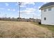 Expansive backyard enclosed by a wooden fence, offering plenty of open space and privacy, as well as some mature trees at 305 Wingate Ct, Shelby, NC 28152