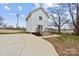 Charming two-story home featuring white siding, a concrete driveway, and a welcoming front entrance with wood steps at 305 Wingate Ct, Shelby, NC 28152