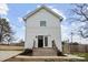 Inviting two-story home with a charming front entrance, featuring white siding and a well-maintained wooden staircase at 305 Wingate Ct, Shelby, NC 28152