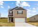Charming two-story home featuring a brick and siding exterior, attached two-car garage, and a well-manicured lawn at 321 Brinkley Dr, Kings Mountain, NC 28086