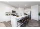Contemporary kitchen featuring a large center island, stainless steel appliances, white cabinetry, and a sleek design at 321 Brinkley Dr, Kings Mountain, NC 28086