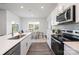 Well-equipped kitchen with stainless steel appliances, white cabinets, ample counter space, and an adjacent dining area at 321 Brinkley Dr, Kings Mountain, NC 28086