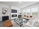 Contemporary living room with a sleek fireplace, neutral tones, and ample natural light creating a warm and inviting atmosphere at 321 Brinkley Dr, Kings Mountain, NC 28086