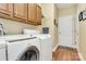 Laundry room with washer, dryer, and wooden cabinets at 3229 Sapphire Ln, Fort Mill, SC 29708