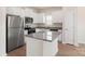 Modern kitchen with white cabinets, granite island, and stainless steel appliances at 3238 Maple Ridge Dr, Gastonia, NC 28052