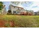 Backyard showcasing a wood deck, green grass, and wooded fence at 5707 Brandy Ridge Ln, Charlotte, NC 28269