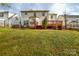 Backyard featuring a wood deck, green grass, and wooden fencing at 5707 Brandy Ridge Ln, Charlotte, NC 28269