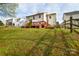 Backyard featuring green grass, wooden fencing, and a wood deck at 5707 Brandy Ridge Ln, Charlotte, NC 28269