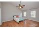Bedroom with hardwood floors, ceiling fan, vaulted ceiling, and natural light from the windows at 5707 Brandy Ridge Ln, Charlotte, NC 28269