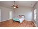 Bedroom with hardwood floors, ceiling fan, and natural light from the windows at 5707 Brandy Ridge Ln, Charlotte, NC 28269