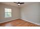 This bedroom features wood laminate floors, wainscotting and a ceiling fan at 5707 Brandy Ridge Ln, Charlotte, NC 28269
