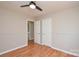 This bedroom features wood laminate floors, wainscotting and a ceiling fan at 5707 Brandy Ridge Ln, Charlotte, NC 28269