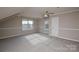 Large bonus room featuring unique architecture, lots of natural light and carpeted floors at 5707 Brandy Ridge Ln, Charlotte, NC 28269