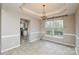 Open dining room space with chandelier, large window, and neutral paint scheme at 5707 Brandy Ridge Ln, Charlotte, NC 28269