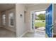 Open foyer with tiled floors, coat hooks, front door with decorative glass and view to front yard at 5707 Brandy Ridge Ln, Charlotte, NC 28269