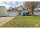 Charming two-story home featuring a well-manicured lawn and a welcoming blue front door and shutters at 5707 Brandy Ridge Ln, Charlotte, NC 28269