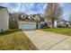Beautiful two-story home showcasing a lush green lawn and long driveway leading to an attached garage at 5707 Brandy Ridge Ln, Charlotte, NC 28269