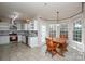 Bright kitchen with dining area, stainless appliances, and white cabinets and tile flooring at 5707 Brandy Ridge Ln, Charlotte, NC 28269