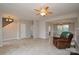 Expansive living room with tile flooring, fireplace, and open access to foyer, dining room, and stairwell at 5707 Brandy Ridge Ln, Charlotte, NC 28269
