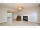 Spacious living room showcasing tile flooring, a fireplace, and an open view into the adjacent dining area at 5707 Brandy Ridge Ln, Charlotte, NC 28269
