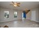 Bright living room featuring tile flooring, large windows, and an open floor plan into the foyer at 5707 Brandy Ridge Ln, Charlotte, NC 28269