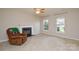 Cozy living room with tiled floors, a fireplace, and two large windows providing plenty of natural light at 5707 Brandy Ridge Ln, Charlotte, NC 28269
